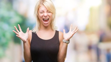 Genç güzel sarışın çekici kadın üzerinde zarif elbise kızgın ve çığlık kaldırdı ve kapalı gözleri heyecanlı silah ile başarı için deli kutluyor arka plan izole. Kazanan kavramı