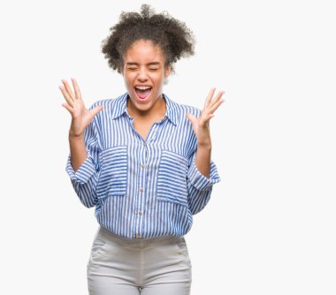 Young afro american woman over isolated background celebrating mad and crazy for success with arms raised and closed eyes screaming excited. Winner concept clipart