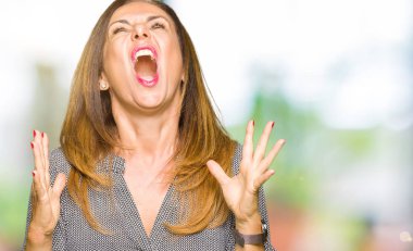 Güzel orta yaş iş kadın çılgın ve kızgın bağırarak ve agresif ifade ve silah kaldırdı bağırıyordu. Hayal kırıklığı kavramı.