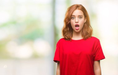 Genç güzel kadın izole arka plan korkuyor ve sürpriz ifade ile şok yüzünden korku ve yüz heyecanlı.