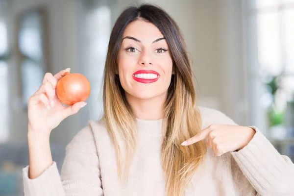 Joven Hermosa Mujer Sosteniendo Cebolla Fresca Casa Con Cara Sorpresa — Foto de Stock