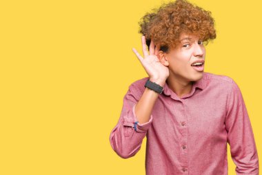 Afro saçlı bir işitme söylenti ya da dedikodu için dinleme kulak üzerinde el ile gülümseyen genç yakışıklı iş adamı. Sağırlık kavramı.