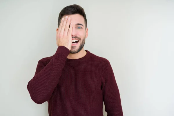 Joven Hombre Guapo Usando Suéter Sobre Fondo Aislado Cubriendo Ojo —  Fotos de Stock