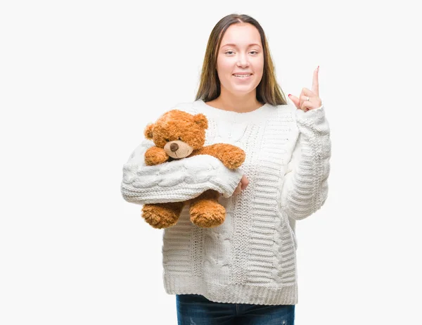 Młoda Kobieta Kaukaski Gospodarstwa Teddy Bear Białym Tle Zaskoczony Pomysłu — Zdjęcie stockowe