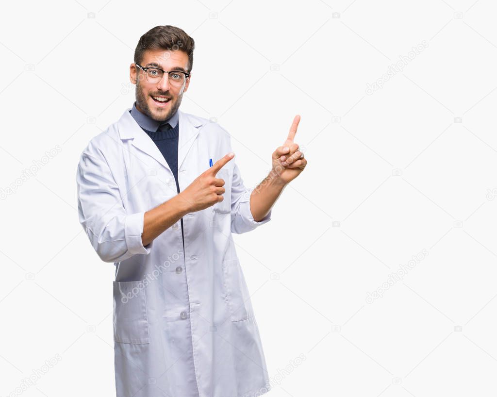 Young handsome man wearing doctor, scientis coat over isolated background smiling and looking at the camera pointing with two hands and fingers to the side.