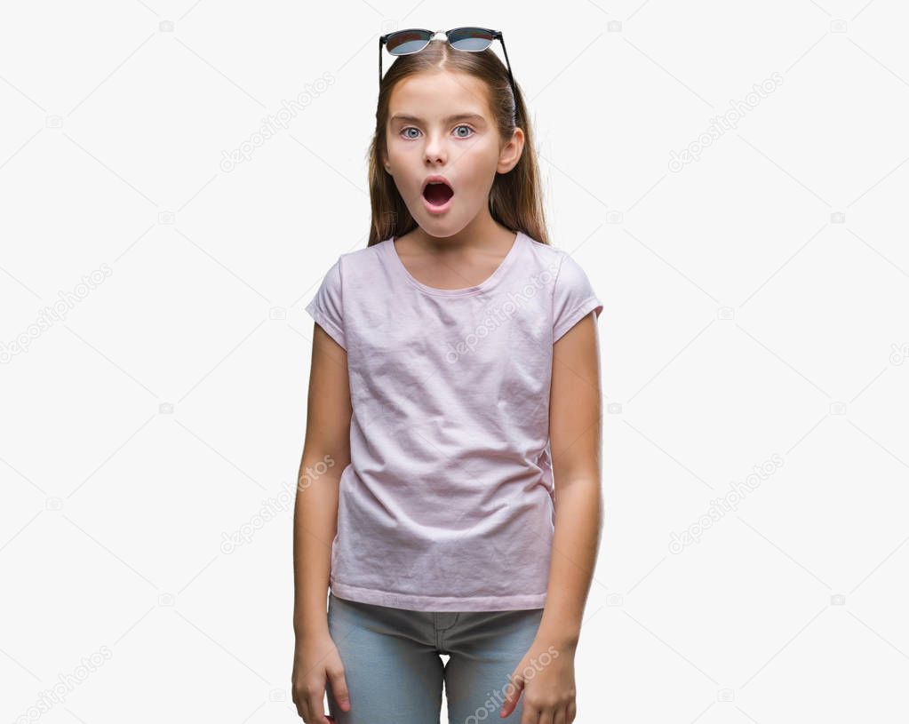 Young beautiful girl wearing sunglasses over isolated background afraid and shocked with surprise expression, fear and excited face.