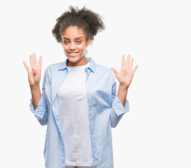 Genç afro Amerikalı kadın gösterilen ve parmakları ile işaret izole arka plan üzerinde numara 9 kendinden emin ve mutlu gülümseyerek süre.
