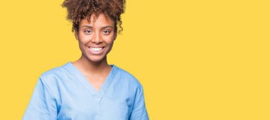 Genç Afro-Amerikan doktor kadın yüzünde mutlu ve güzel bir gülümseme ile izole arka plan yüzünden. Şanslı kişi.
