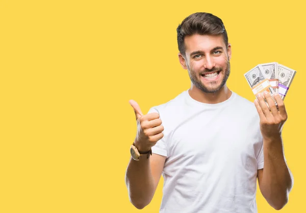 Joven Hombre Guapo Sosteniendo Pila Dólares Sobre Fondo Aislado Feliz — Foto de Stock