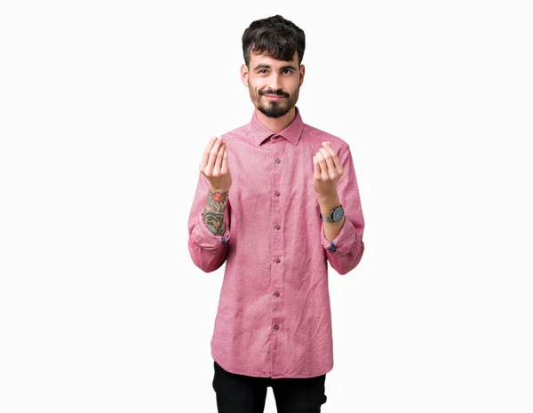 年轻英俊的男人穿着粉红色的衬衫在孤立的背景做金钱手势用手 要求薪水薪水 百万富翁企业 — 图库照片