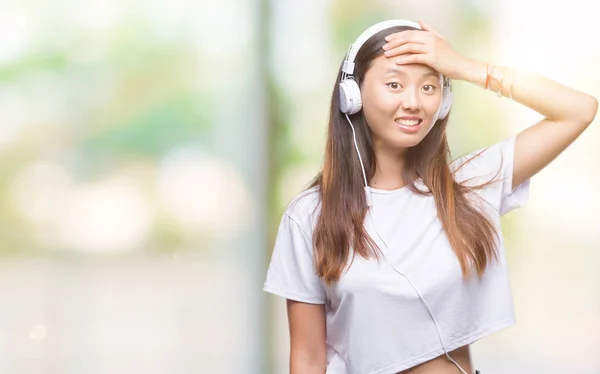 Young Asian Woman Listening Music Wearing Headphones Isolated Background Stressed — Stock Photo, Image