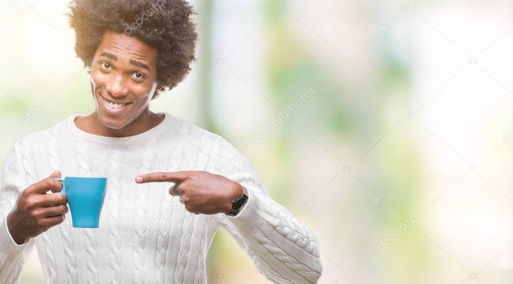 Afro american man drinking cup of coffee over isolated background very happy pointing with hand and finger