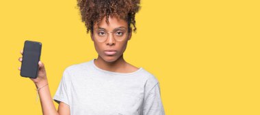 Genç Afro-Amerikan kadın gösteren smartphone ekran acımak yüz ciddi düşünüyorum üstünde kendine güvenen bir ifade ile izole arka plan üzerinde