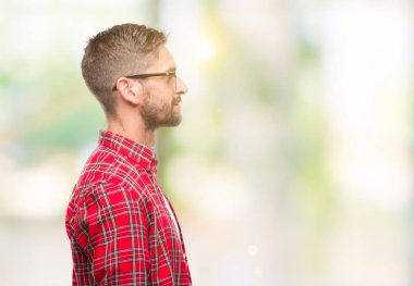 Yakışıklı delikanlı izole arka tarafına, seyir üzerinde dinlenmek doğal yüz emin gülümseme ile pozuyla profili.