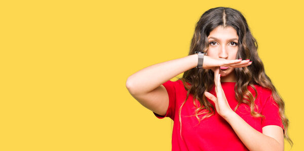 Young beautiful woman wearing casual t-shirt Doing time out gesture with hands, frustrated and serious face