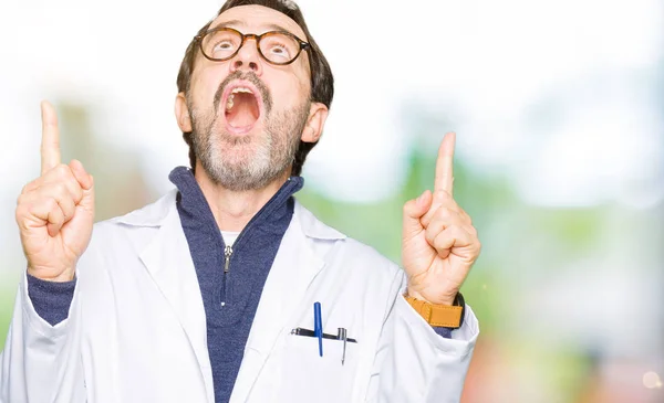 Middle Age Therapist Wearing White Coat Amazed Surprised Looking Pointing — Stock Photo, Image