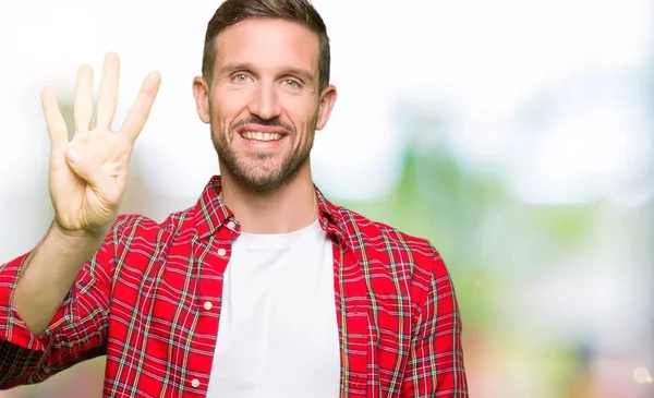 指で上向きの表示とのカジュアルなシャツを着ているハンサムな男性数は自信を持って 幸せな笑みを浮かべている間 — ストック写真