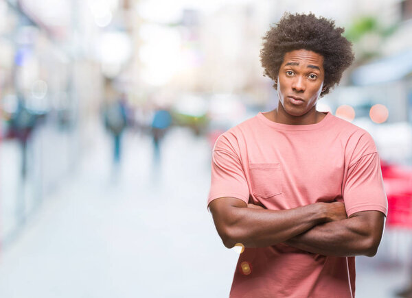 Afro american man over isolated background skeptic and nervous, disapproving expression on face with crossed arms. Negative person.