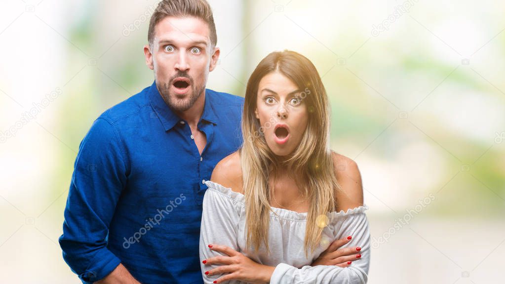 Young couple in love over isolated background afraid and shocked with surprise expression, fear and excited face.