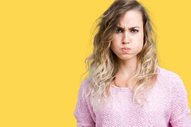 Beautiful young blonde woman over isolated background puffing cheeks with funny face. Mouth inflated with air, crazy expression. clipart