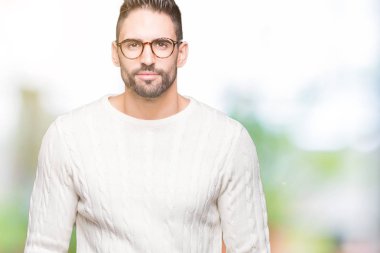 Üzerinde gözlük takan genç yakışıklı adam arka plan gevşek yüzünde ciddi bir ifade ile izole. Basit ve doğal kameraya bakıyor.