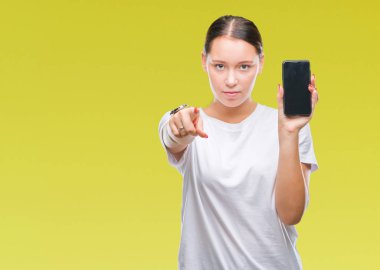 Genç güzel beyaz kadın gösteren smartphone ekran kamera ve size parmak ile işaret izole arka plan üzerinde el işareti, pozitif ve kendinden emin bir jest ön