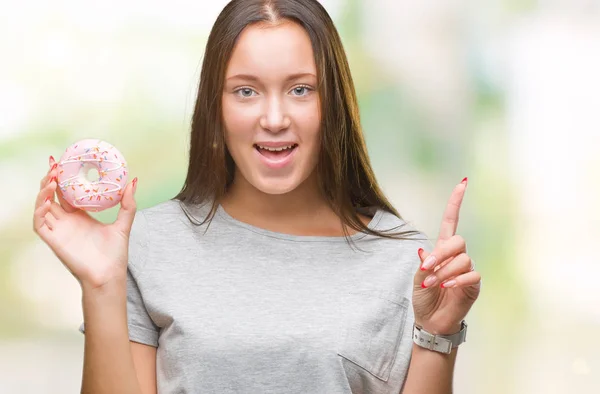 Jeune Femme Caucasienne Mangeant Beignet Sucré Sur Fond Isolé Surpris — Photo