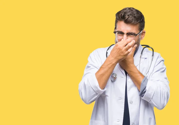 Young Handsome Doctor Man Isolated Background Smelling Something Stinky Disgusting — Stock Photo, Image