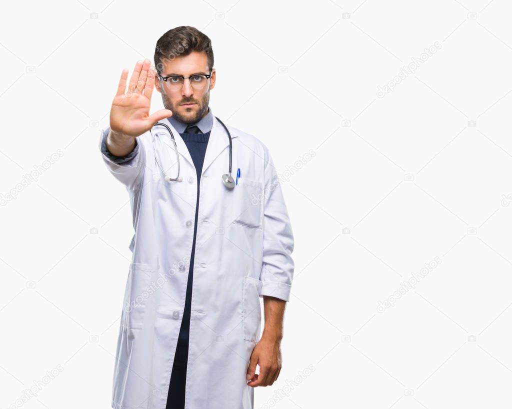 Young handsome doctor man over isolated background doing stop sing with palm of the hand. Warning expression with negative and serious gesture on the face.