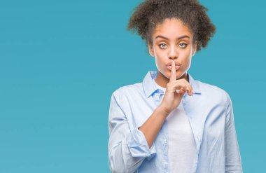 Dudaklarında parmak ile sessiz olmanı izole arka plan üzerinde genç afro Amerikalı kadın. Sessizlik ve gizli kavramı.