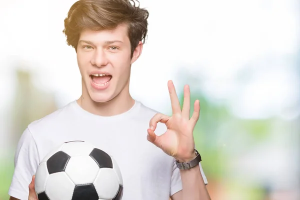 Joven Sosteniendo Pelota Fútbol Sobre Fondo Aislado Haciendo Signo Con — Foto de Stock