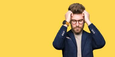 Genç yakışıklı iş adamı gözlük çünkü umutsuz ve stresli baş ağrısı acı acı ve migren. Ellerini kafasına.