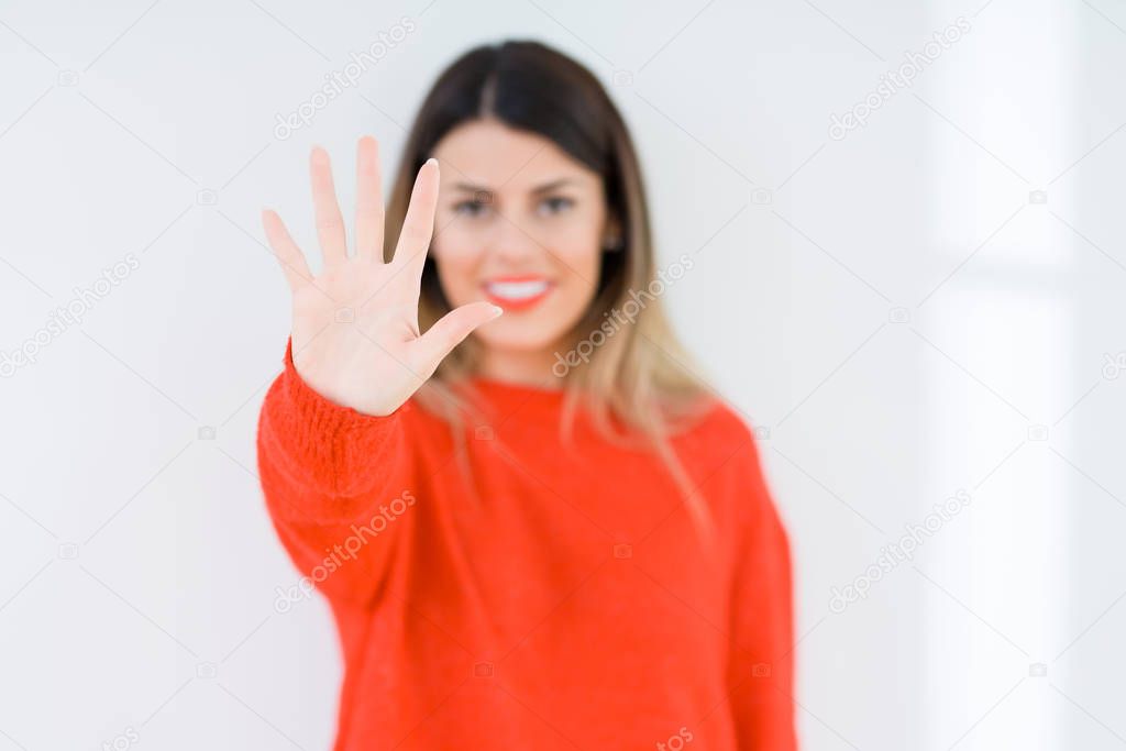 Young woman wearing casual red sweater over isolated background showing and pointing up with fingers number five while smiling confident and happy.