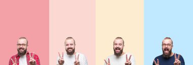 Kolaj bir zafer işareti yapıyor parmak gösterilen kamera seyir gülümseyen izole renkli çizgili arka plan üzerinde sakallı genç adam. İki numaralı.