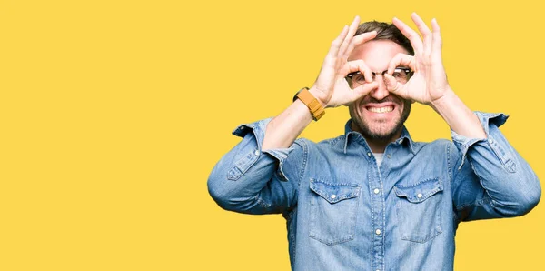 Handsome Man Wearing Glasses Doing Gesture Binoculars Sticking Tongue Out — Stock Photo, Image