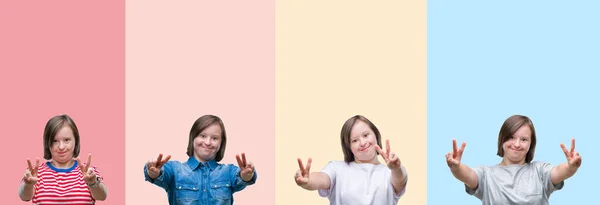 勝利のサインをやって指を表示するカメラを笑みを浮かべてカラフルなストライプ分離背景上ダウン症女性のコラージュ — ストック写真