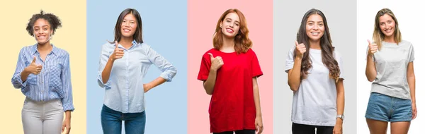 Collage of hispanic, african american, asian, indian women over vintage color background doing happy thumbs up gesture with hand. Approving expression looking at the camera with showing success.