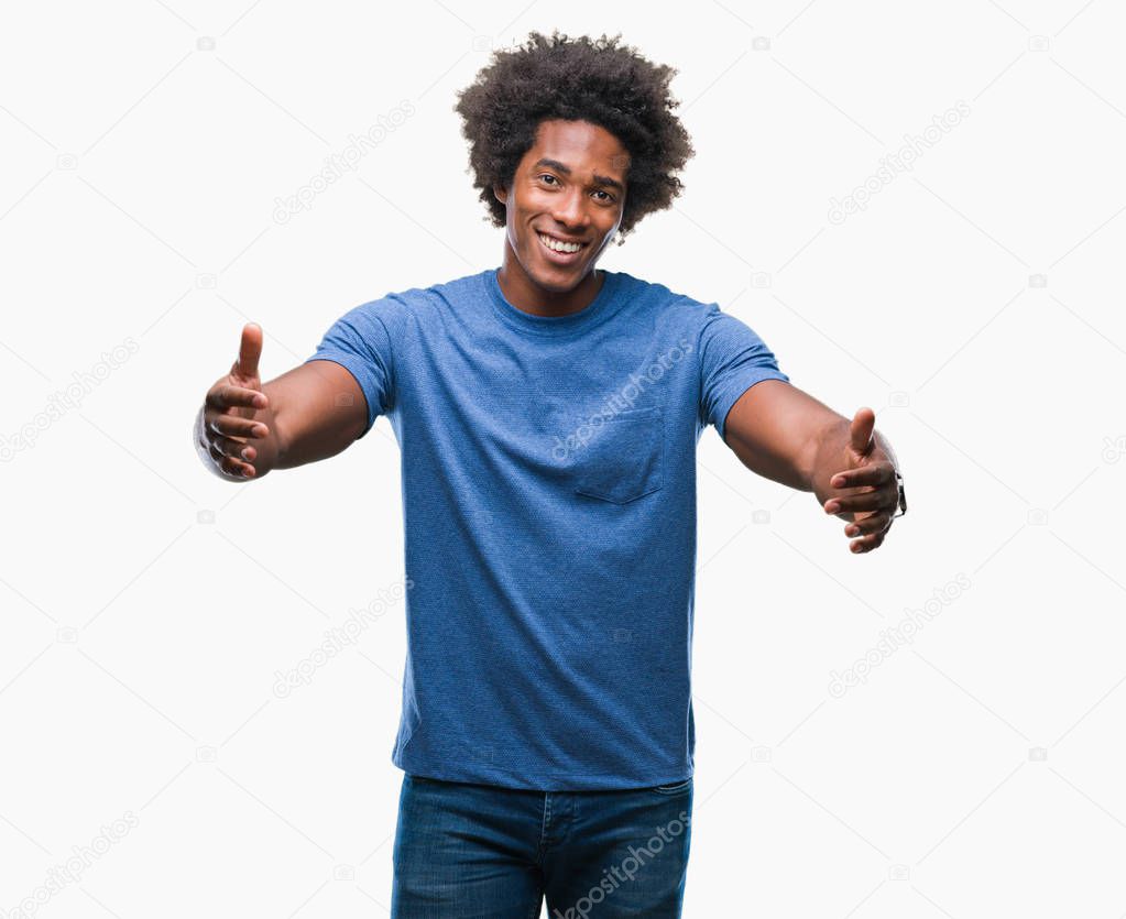 Afro american man over isolated background looking at the camera smiling with open arms for hug. Cheerful expression embracing happiness.