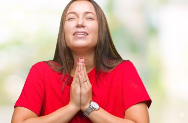 Genç güzel beyaz kadın dilencilik ve umut ifade yüzünde çok duygusal ve endişe ile birlikte elleriyle dua izole arka plan yüzünden. Bağışlanmak. Din kavramı.