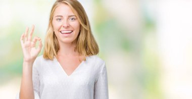 Gülümseyen izole arka plan üzerinde güzel genç zarif kadın el ve parmaklar ok işaretiyle yapıyor olumlu. Başarılı ifade.