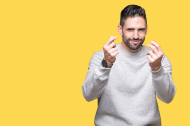 Maaş ödeme için milyoner iş soran izole arka plan yapıyor para hareketi el ile üzerinden sweatshirt giyen genç yakışıklı adam