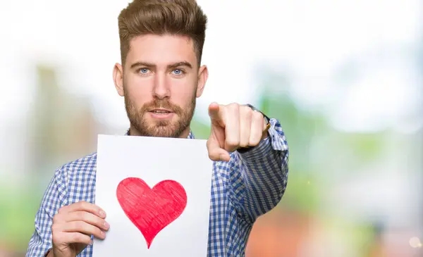 Young Handsome Man Holding Paper Red Heart Pointing Finger Camera — Stock Photo, Image