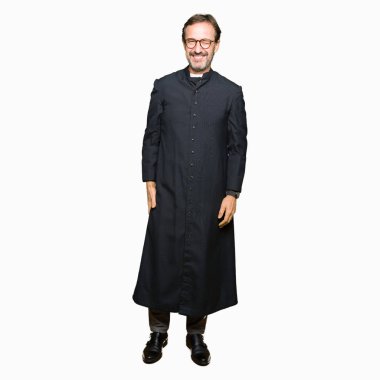 Katolik giyen orta yaş rahip adam robe seksi bir ifadeyle, neşeli ve mutlu yüzünü kameraya bakarak göz kırpıyor.