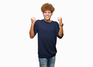 Afro kutluyor gözlük takan genç yakışıklı adamla şaşırttı ve başarı için kaldırdı kollarını açarak hayret ve gözleri açık. Kazanan kavramı.