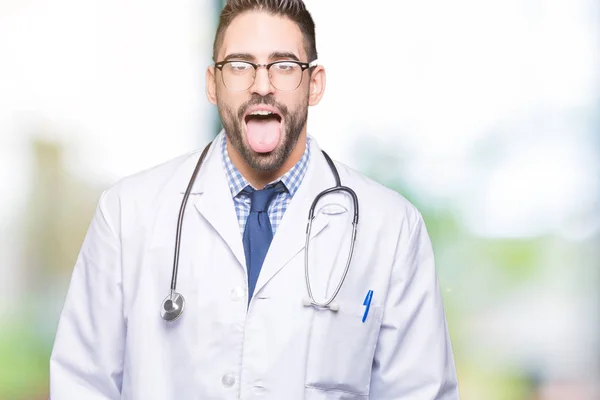 Guapo Joven Doctor Hombre Sobre Aislado Fondo Palpitante Lengua Fuera —  Fotos de Stock