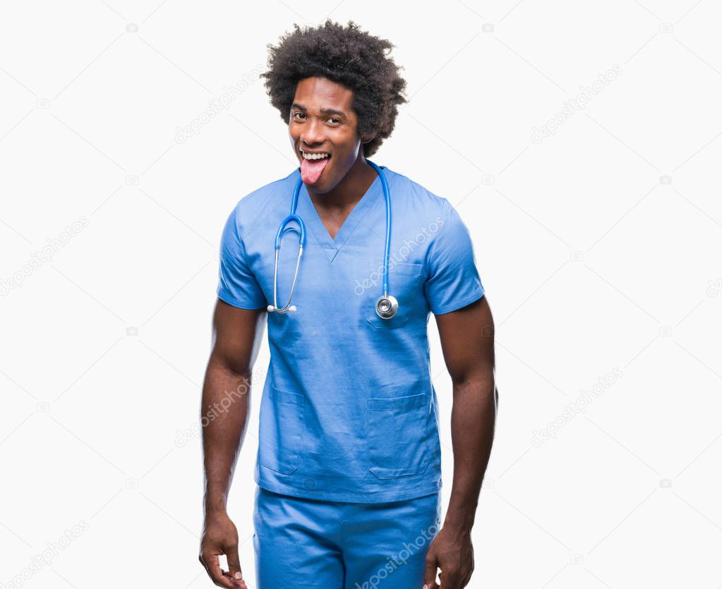 Afro american surgeon doctor man over isolated background sticking tongue out happy with funny expression. Emotion concept.