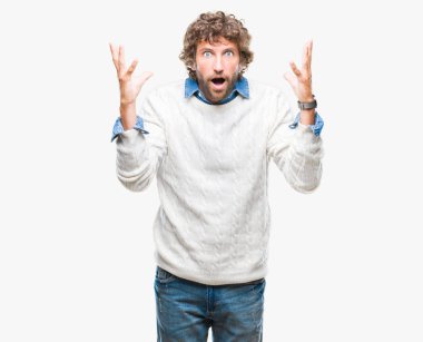 İspanyol yakışıklı modeli izole arka plan kutlama üzerinde giyen kış kazak çılgın ve çığlık kaldırdı ve açık gözleri heyecanlı silah ile başarı için hayran. Kazanan kavramı