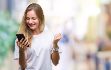 Duygu tezahürat smartphone gurur çığlık ve zafer ve başarı çok heyecanlı, kutluyor izole arka plan üzerinde kullanan genç güzel sarışın kadın