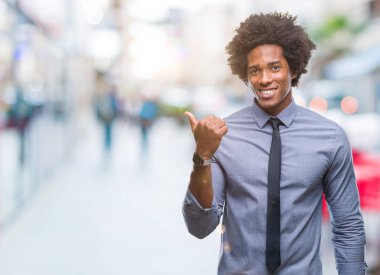 Afro Amerikalı iş adamı arıyor ve başparmak yanında yukarıyı mutlu yüz ile gülümseyen izole arka plan üzerinde.