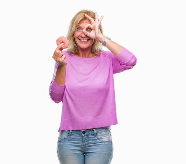 Medelålders Blond Kvinna Äta Rosa Donut Över Isolerade Bakgrund Med — Stockfoto